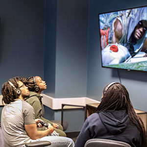 NEH Award for Critical Game Studies. Photo of students gaming. Link to NEH Award for Critical Game Studies.